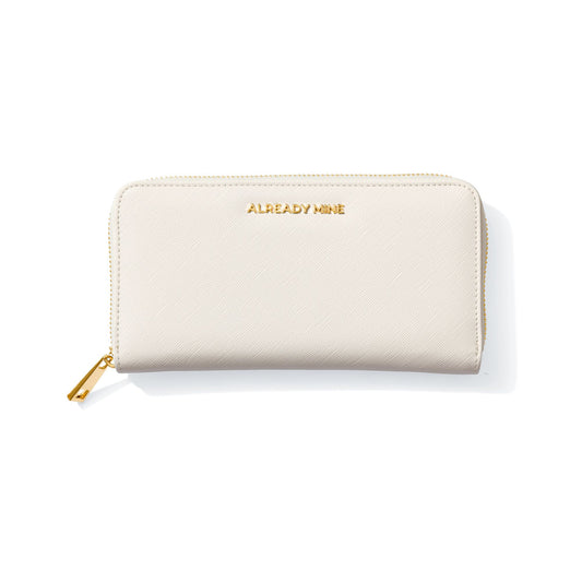 Luxury Ecru Manifesting Wallet with golden "ALREADY MINE" affirmation logo.